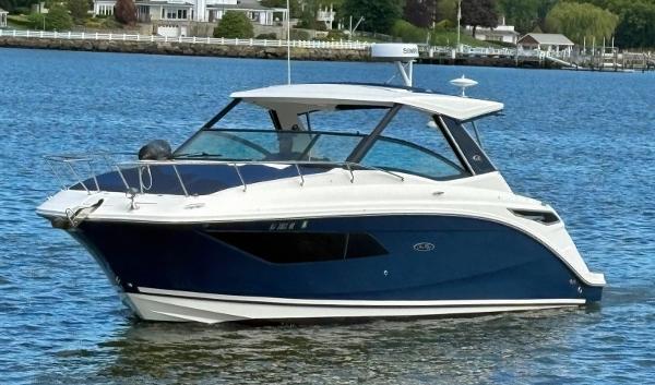 Sea Ray 320 Sundancer 2020 Sea Ray 320 Sundancer boat on calm water, featuring sleek design and modern amenities.