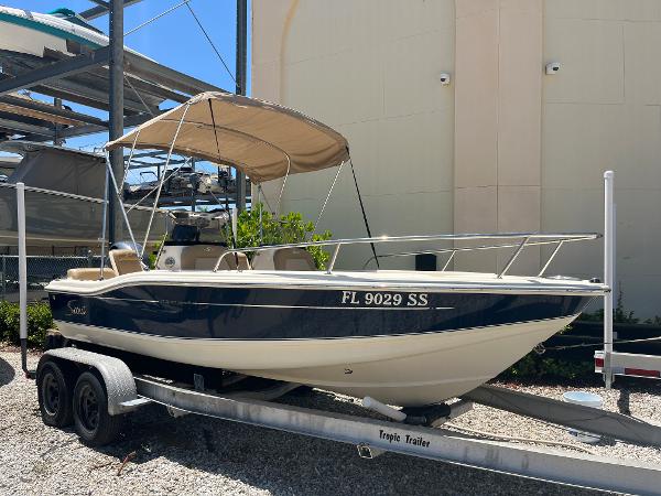 Scout 175 Dorado 2020 Scout 175 Dorado boat on trailer with canopy in storage facility.