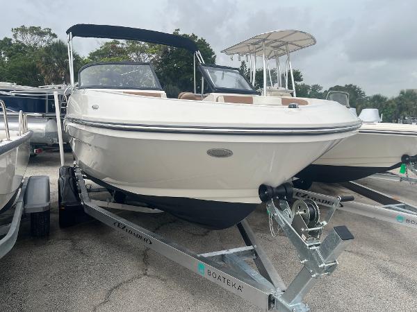 Bayliner VR5 Bowrider OB 2021 Bayliner VR5 Bowrider OB on trailer, parked outdoors, with canopy and sleek design.