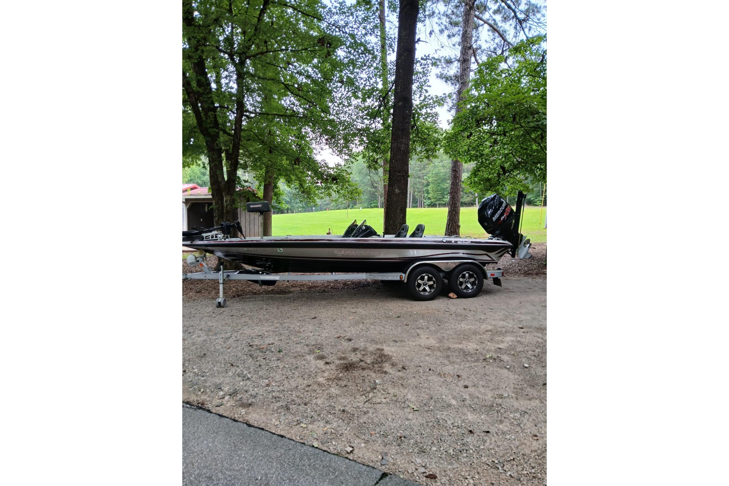Phoenix 921 ProXP 2014 Phoenix 921 ProXP boat on trailer, parked in wooded area.