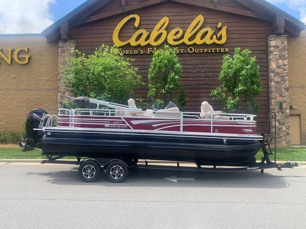 Ranger 223F 2023 Ranger 223F pontoon boat on trailer outside Cabela's store.