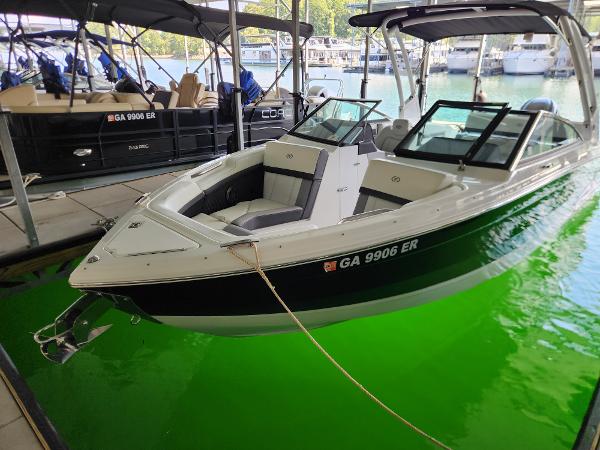 Cobalt R4 Outboard 2023 Cobalt R4 Outboard boat docked in marina with vibrant green water.
