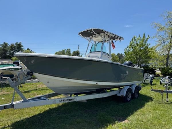 Mako 214 CC 2020 Mako 214 CC boat on trailer, parked on grass under clear blue sky.