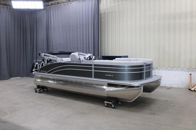 Harris Cruiser 210 2026 Harris Cruiser 210 pontoon boat in a showroom setting.