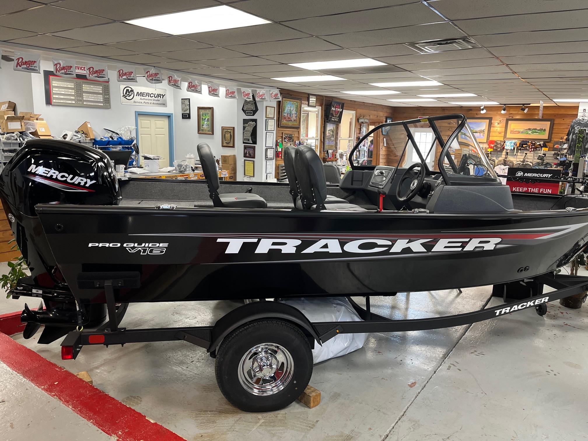 Tracker Pro Guide V-16 WT 2025 Tracker Pro Guide V-16 WT boat displayed indoors with Mercury engine.