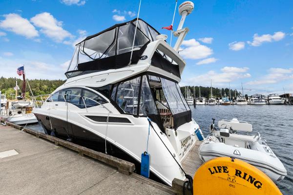 Sea Ray 400 Fly 2017 Sea Ray 400 Fly yacht docked at marina with inflatable boat and life ring.