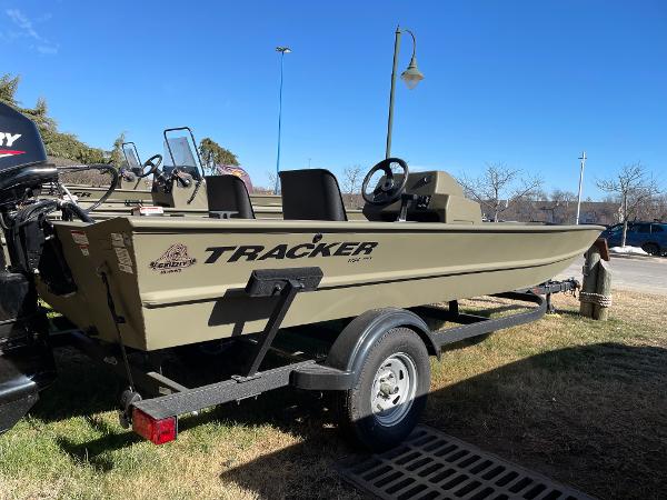 Tracker Grizzly 1754 2023 Tracker Grizzly 1754 boat on trailer, parked outdoors under clear blue sky.