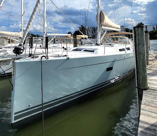 Hanse 458 2019 Hanse 458 sailboat docked at marina under cloudy sky.