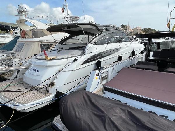 Princess V48 Open 2016 Princess V48 Open yacht docked at a marina, showcasing sleek design and luxury features.