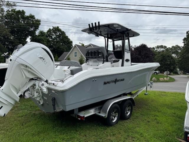 NauticStar 242 Offshore 2025 NauticStar 242 Offshore boat on trailer, parked on grass.