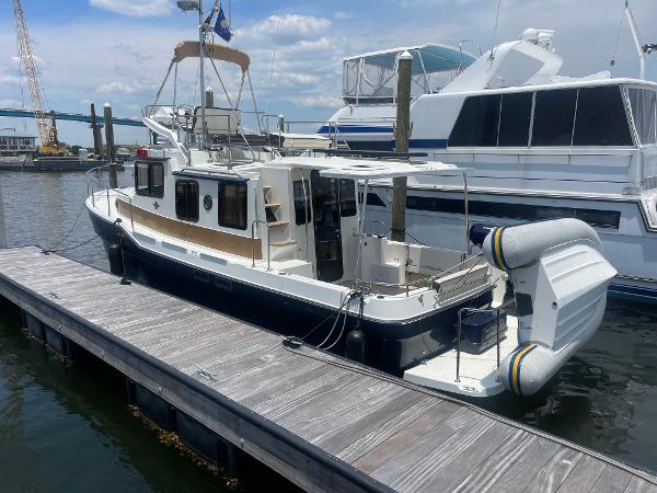 Ranger Tugs R-31 CB 2023 Ranger Tugs R-31 CB docked at marina, featuring sleek design and spacious deck.