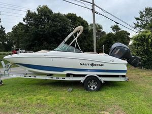NauticStar 203 DC Deck 2025 NauticStar 203 DC Deck boat on trailer, parked on grass.