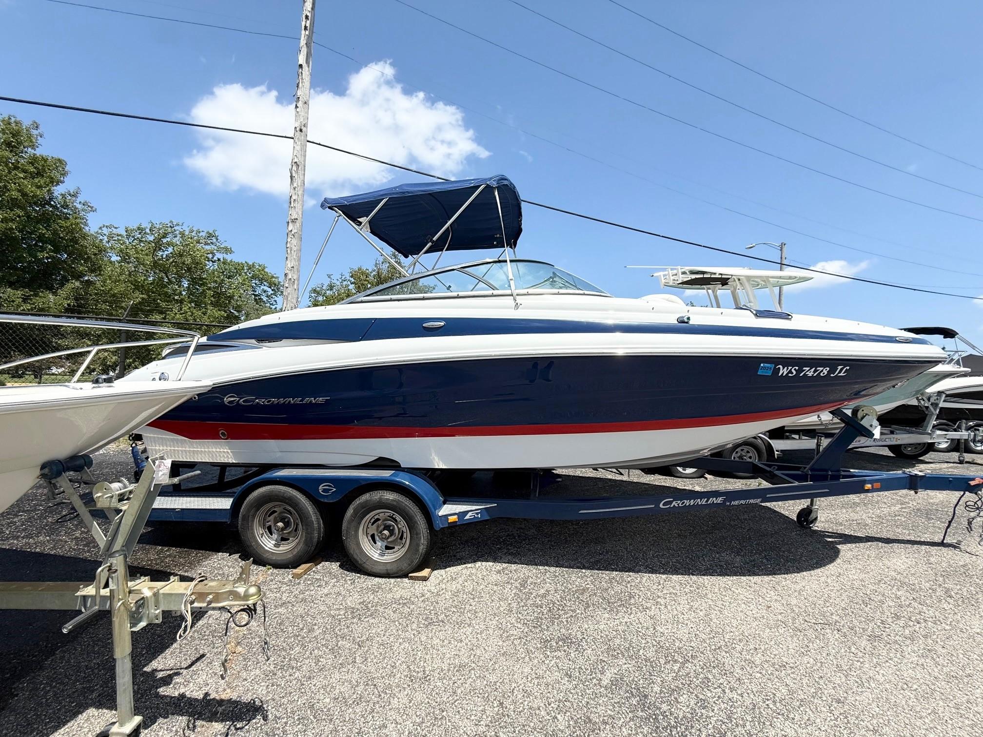 Crownline Eclipse E4 2016 Crownline Eclipse E4 boat on trailer, blue and white design, parked outdoors.