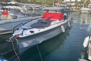 Axopar 37 2021 Axopar 37 boat docked in marina with red cover and fenders.