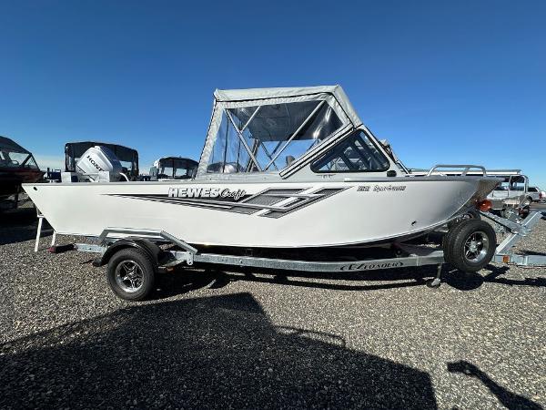 Hewescraft 200 Sportsman 2025 Hewescraft 200 Sportsman boat on trailer, side view, clear sky background.