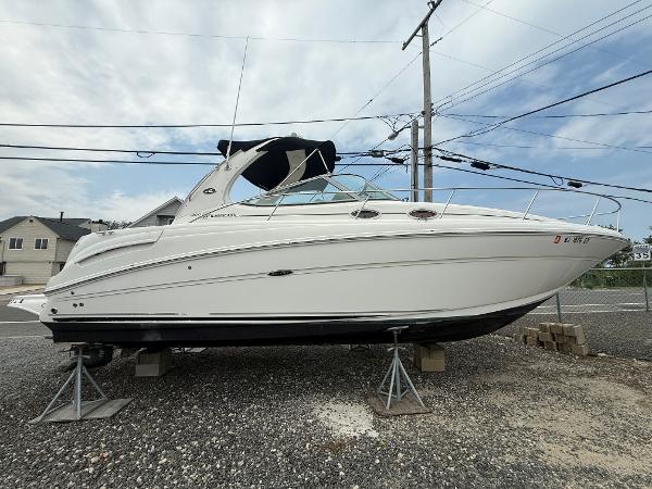 Sea Ray 300 Sundancer 2006 Sea Ray 300 Sundancer boat on stands, displayed outdoors under cloudy sky.