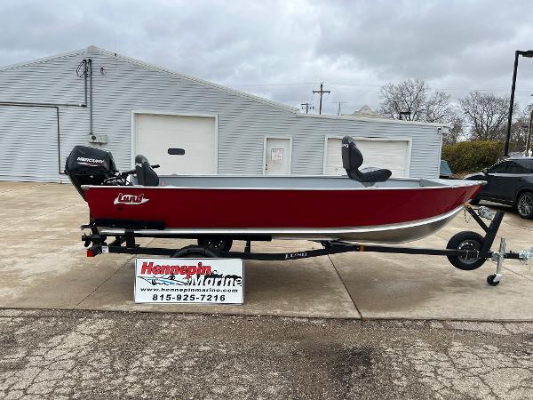 Lund 1600 Fury Tiller 2025 Lund 1600 Fury Tiller boat on trailer, red exterior, displayed at Hennepin Marine dealership.