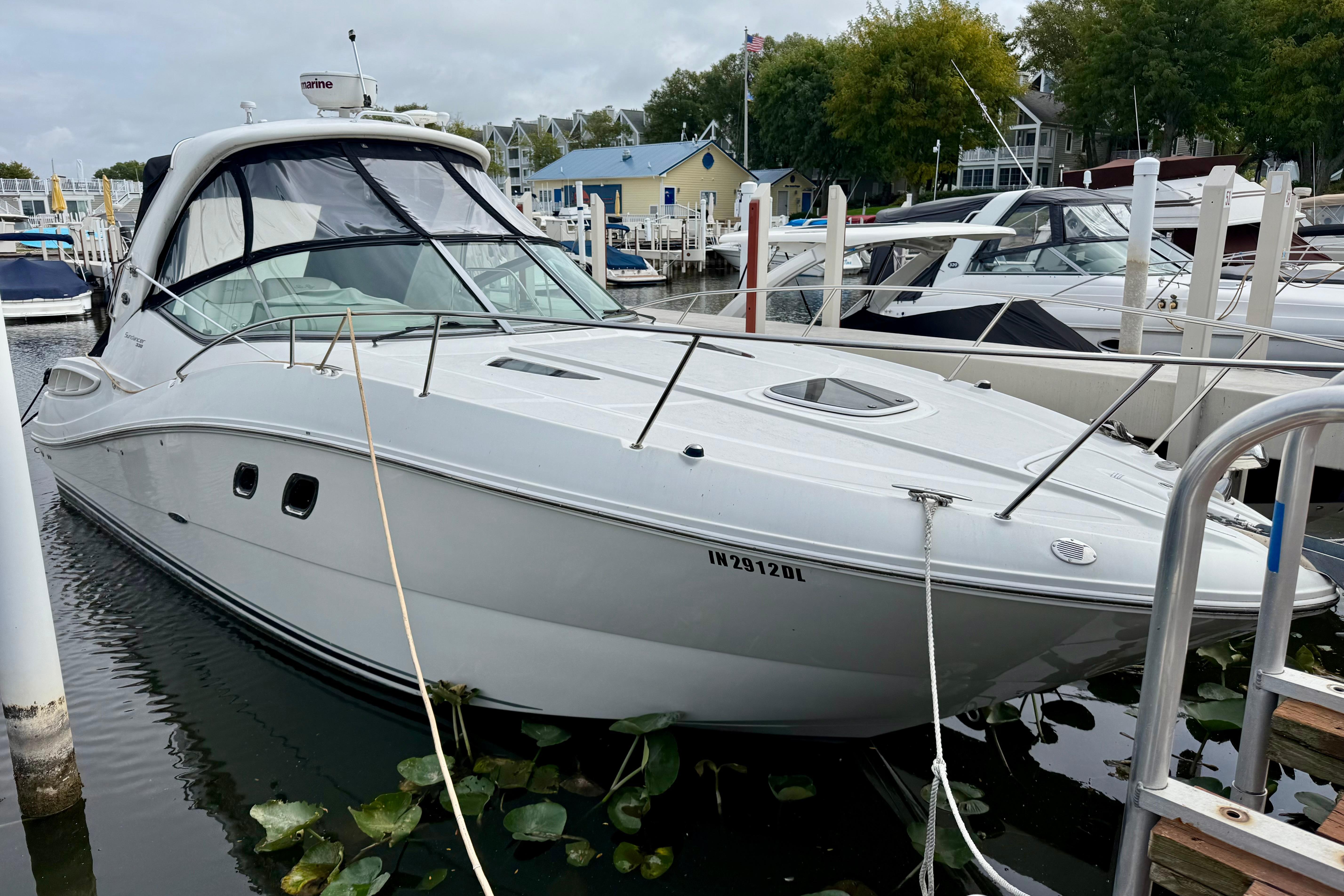 Sea Ray 330 Sundancer 2010 Sea Ray 330 Sundancer docked at a marina, surrounded by other boats.