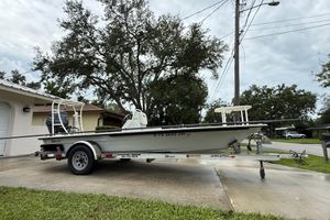 Maverick 17 HPX-S 2021 Maverick 17 HPX-S boat on trailer, parked in driveway, surrounded by trees.