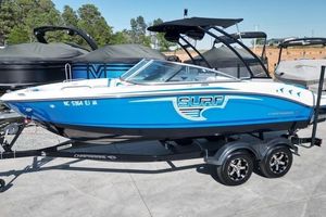 Chaparral 21 H2O Surf 2019 Chaparral 21 H2O Surf boat in blue on trailer, parked outdoors.