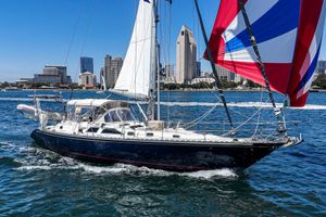 Hylas 49 Sailing yacht Hylas 49 (2001) cruising near city skyline on a sunny day.