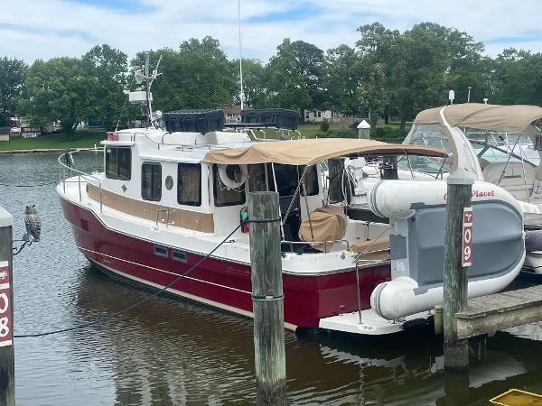 Ranger Tugs R-31 2014 Ranger Tugs R-31 boat docked in a marina with trees in the background.