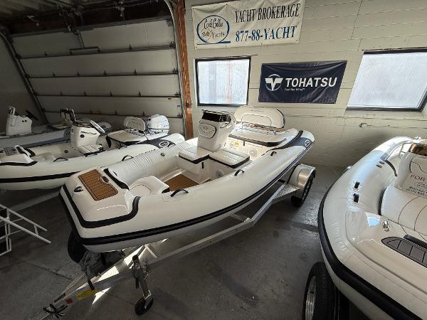 Walker Bay Generation 14 LTE 2025 Walker Bay Generation 14 LTE boat displayed in a showroom with other boats.