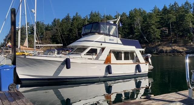 Ocean Alexander 40 Sedan 1983 Ocean Alexander 40 Sedan yacht docked in a serene marina setting.
