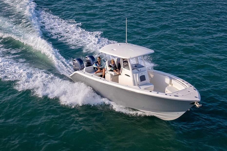 Cobia 280 Center Console 2022 Cobia 280 Center Console boat cruising on open water.