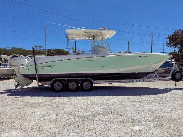 Boston Whaler 320 Outrage 2004 Boston Whaler 320 Outrage boat on a trailer in a parking lot.