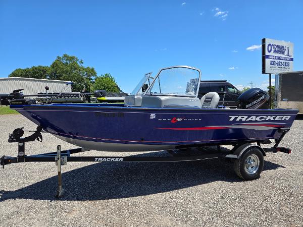 Tracker Pro Guide V-16 WT 2018 Tracker Pro Guide V-16 WT boat on trailer, parked outdoors under clear blue sky.