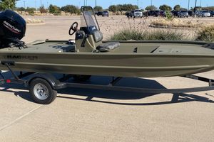 Tracker Grizzly 1860 CC 2026 Tracker Grizzly 1860 CC boat on trailer in parking lot.