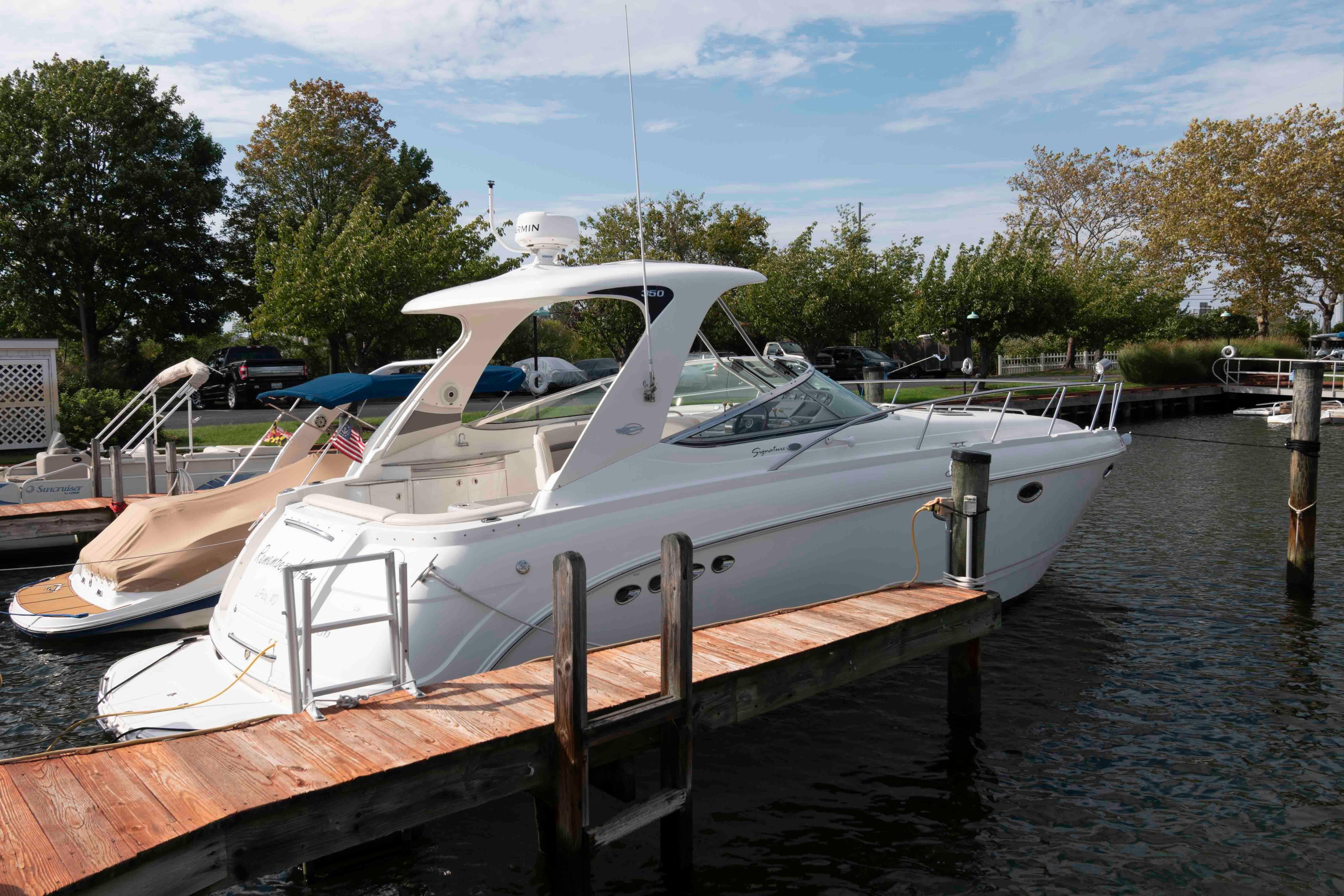 Chaparral Signature 350 2007 Chaparral Signature 350 boat docked at marina, surrounded by trees and calm water.