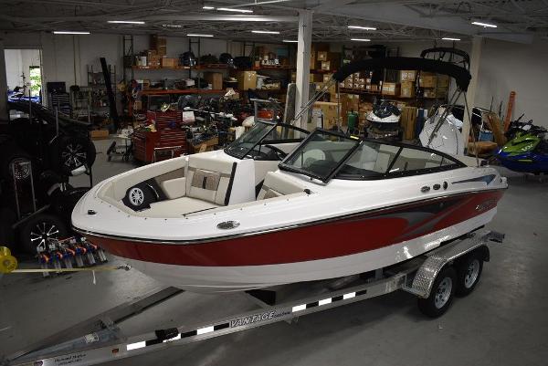 Monterey M-205 2025 Monterey M-205 boat on trailer in a showroom.