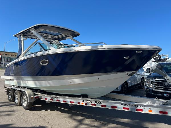 Chaparral 280 OSX 2020 Chaparral 280 OSX boat on trailer, blue and white hull, outdoor display.
