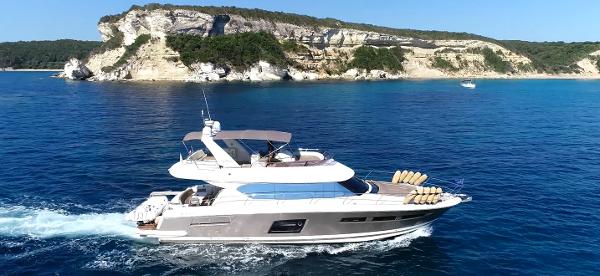 Prestige 620 Luxury Prestige 620 yacht cruising near scenic cliffs, 2013 model.