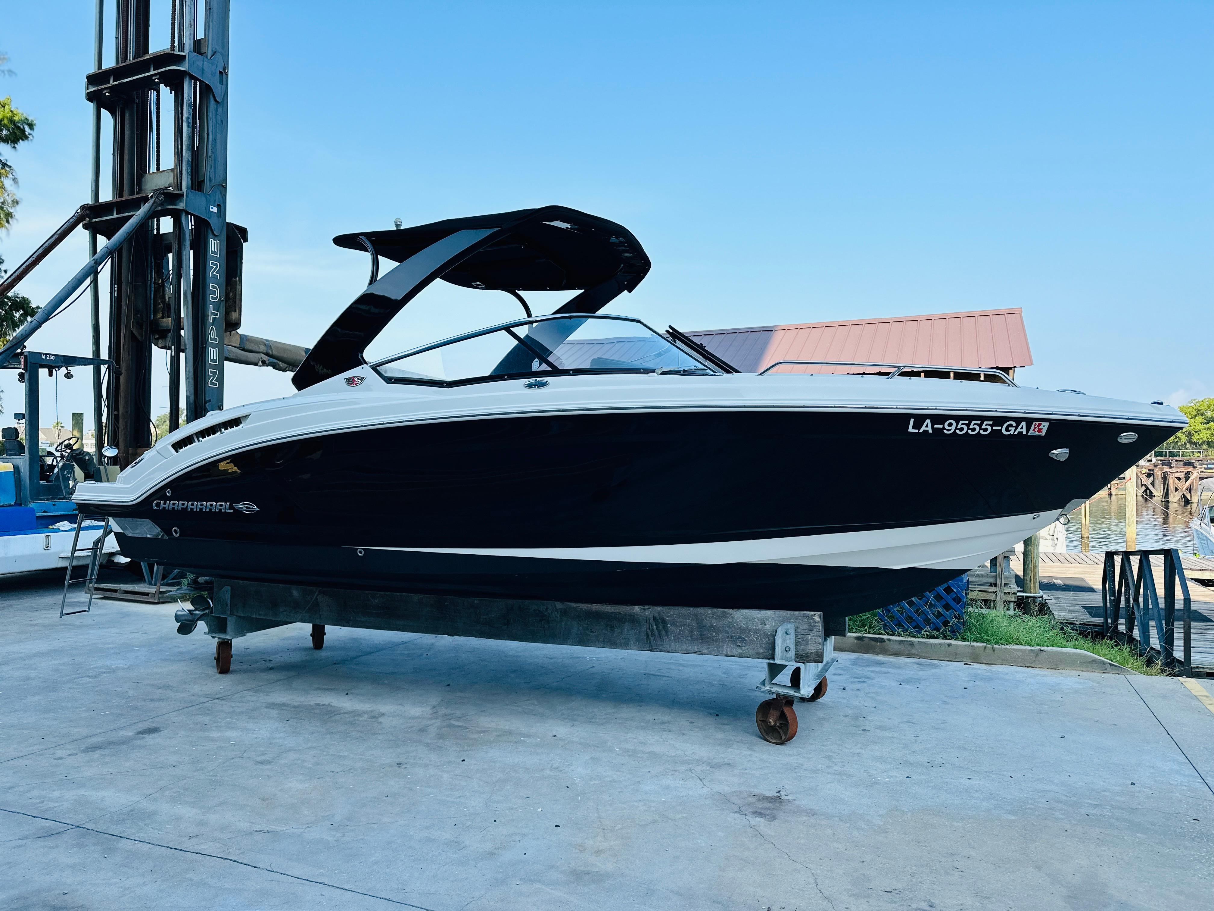 Chaparral 257 SSX 2013 Chaparral 257 SSX boat on a lift, side view, outdoors.