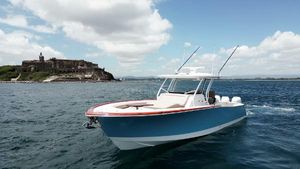 Vicem CC 2025 Vicem CC boat cruising near a historic coastal fort under a partly cloudy sky.