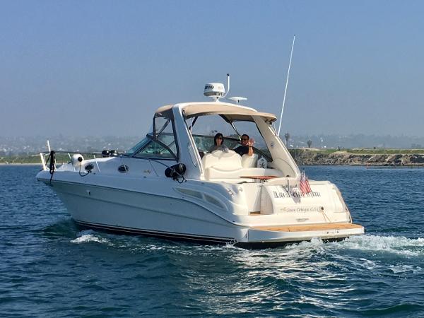 Sea Ray 340 Sundancer 1999 Sea Ray 340 Sundancer cruising on open water, clear sky, two people onboard.