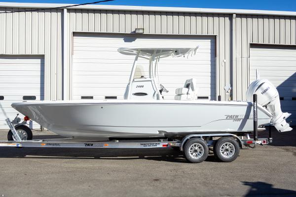 Pathfinder 2400 TRS 2025 Pathfinder 2400 TRS boat on trailer, parked outside a garage.