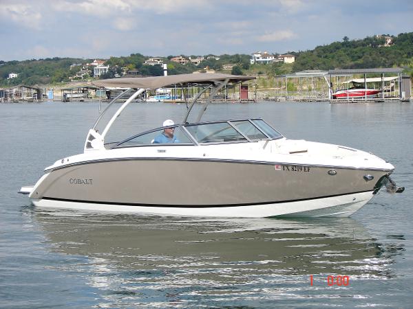 Cobalt R5 2018 Cobalt R5 boat cruising on a lake with scenic background.