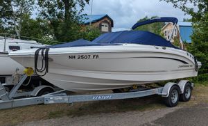 Chaparral 216 SSi 2016 Chaparral 216 SSi boat on trailer, covered, parked outdoors.