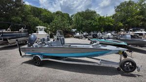Xpress H22B Bay 2026 Xpress H22B boat on trailer, parked outdoors with other boats.