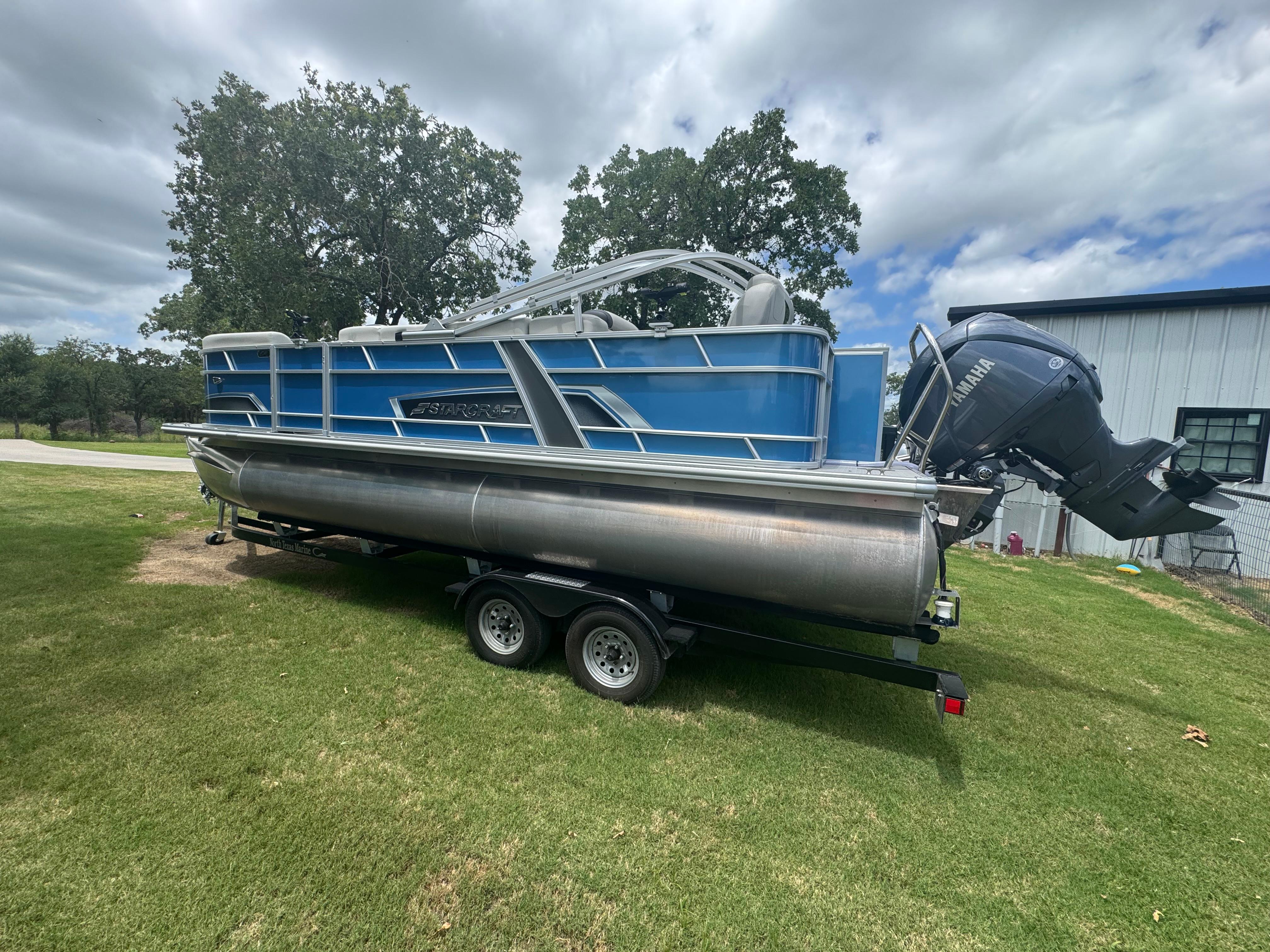 Starcraft EX 22 FD 2025 Starcraft EX 22 FD pontoon boat on trailer, parked on grass.