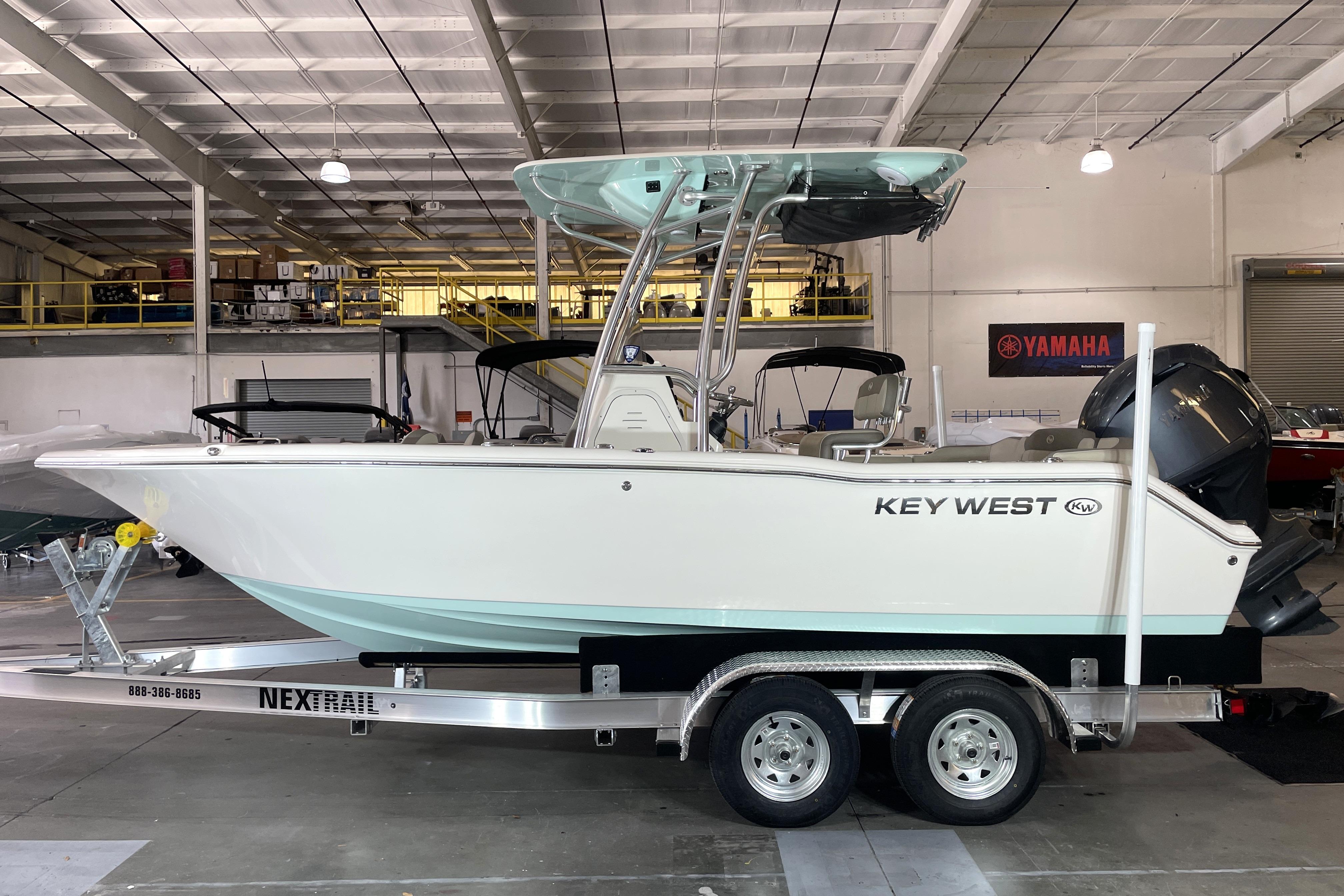 Key West 203 FS 2024 Key West 203 FS boat on trailer in indoor showroom.