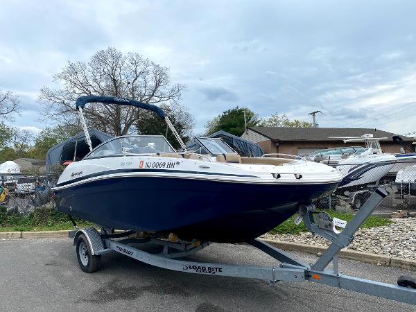 Hurricane SunDeck 191 OB 2019 Hurricane SunDeck 191 OB boat on trailer, parked outdoors.