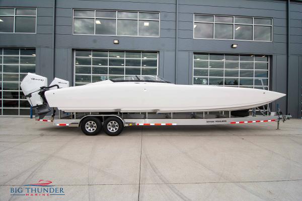 Fountain 34 Thunder Cat 2023 Fountain 34 Thunder Cat boat on a trailer outside a modern building.