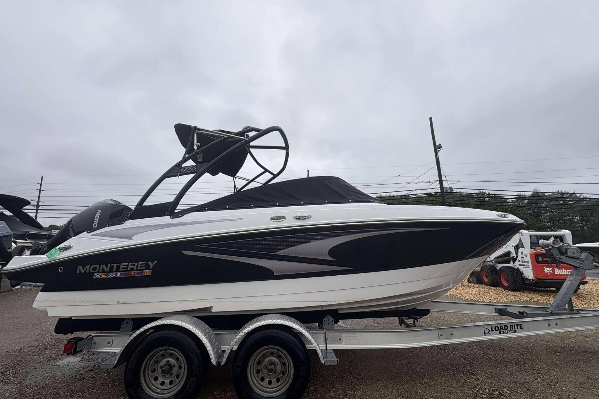 Monterey M205 2024 Monterey M205 boat on trailer, sleek design, black and white color scheme.