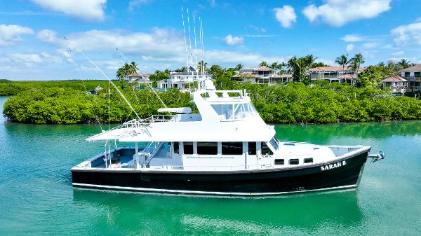 Custom Carolina 58 Dixon Marine Custom Carolina 58 Dixon Marine 2007 yacht on serene water, lush greenery background.