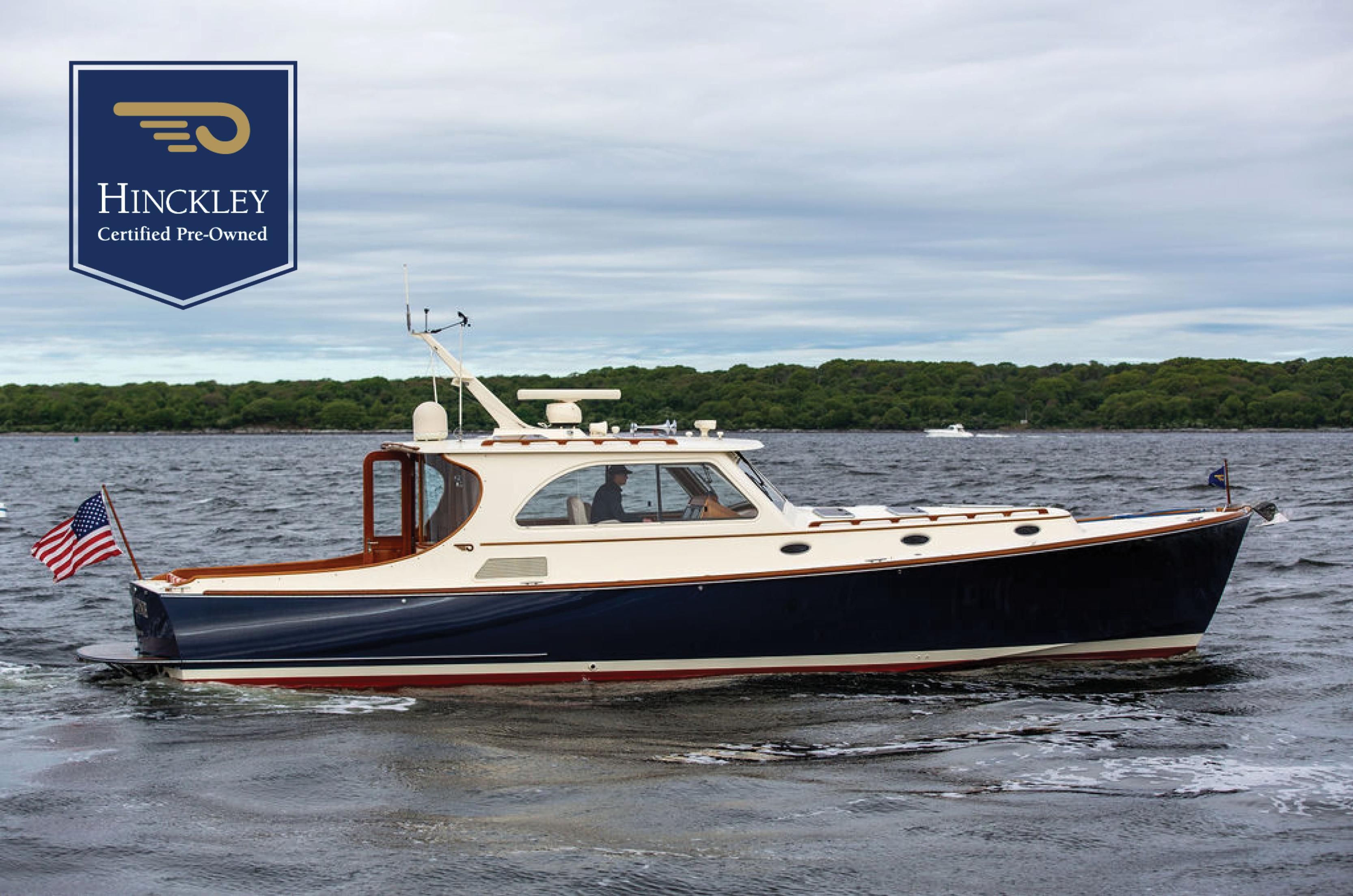 Hinckley Talaria 44 MY 2007 Hinckley Talaria 44 MY yacht on water, certified pre-owned, with American flag.